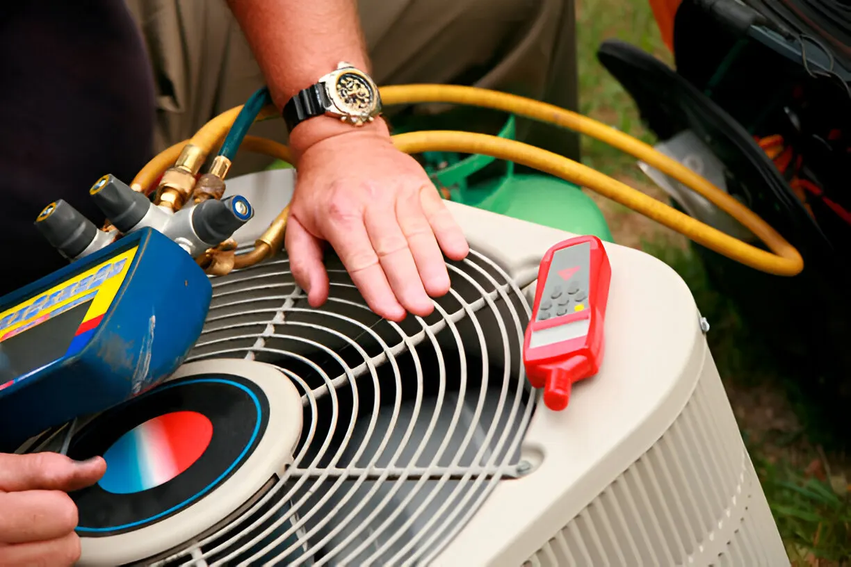 Certified technician repairing an air conditioner unit in Central Los Angeles