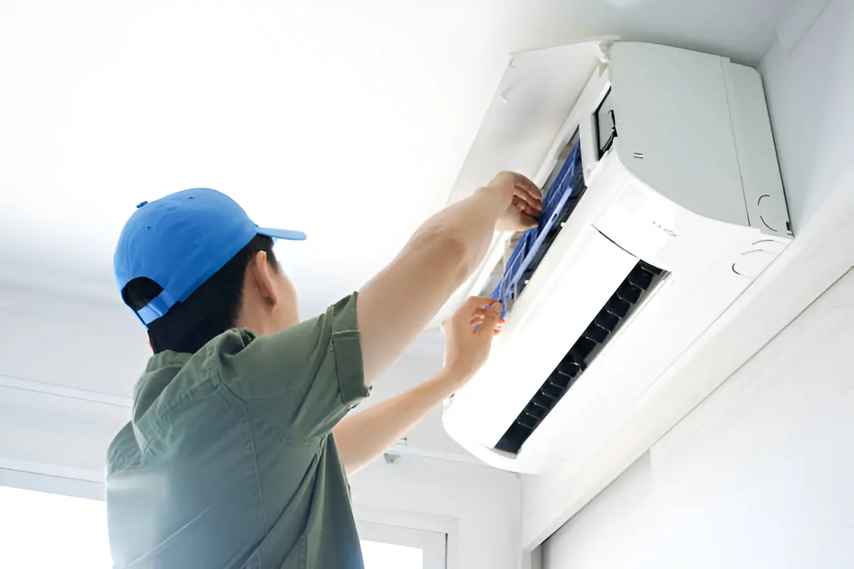 Technician performing air conditioning service in a Los Angeles home