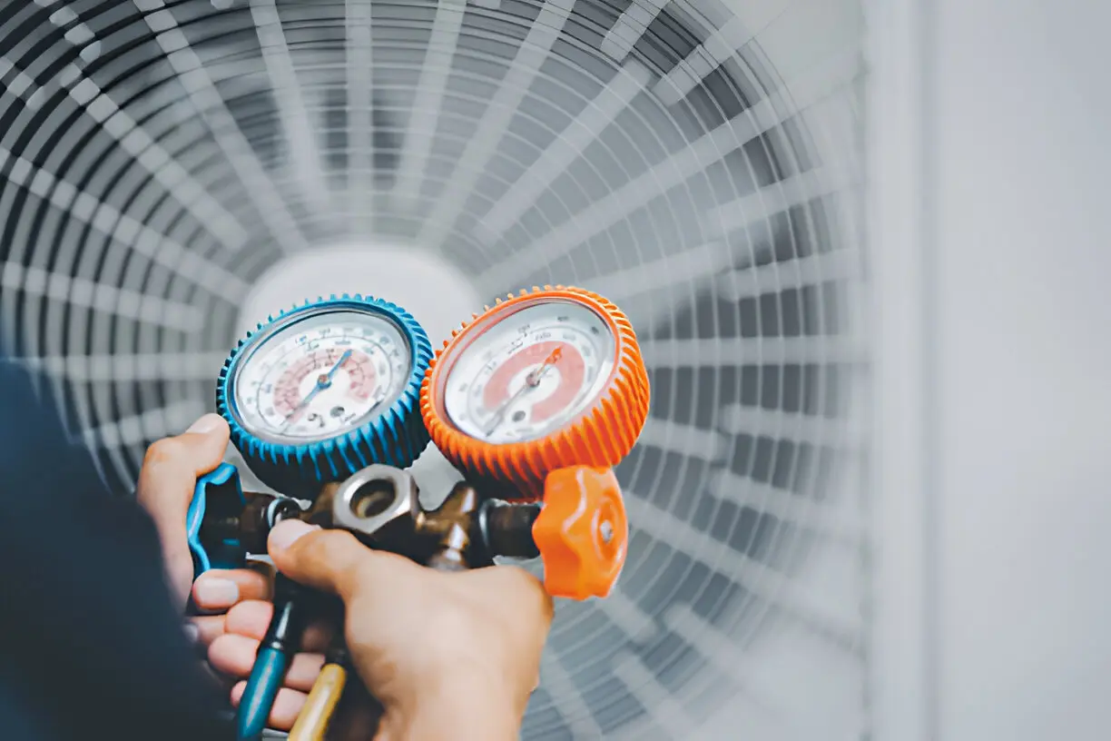 Close-up of a technician fixing a malfunctioning AC unit in a Los Angeles home